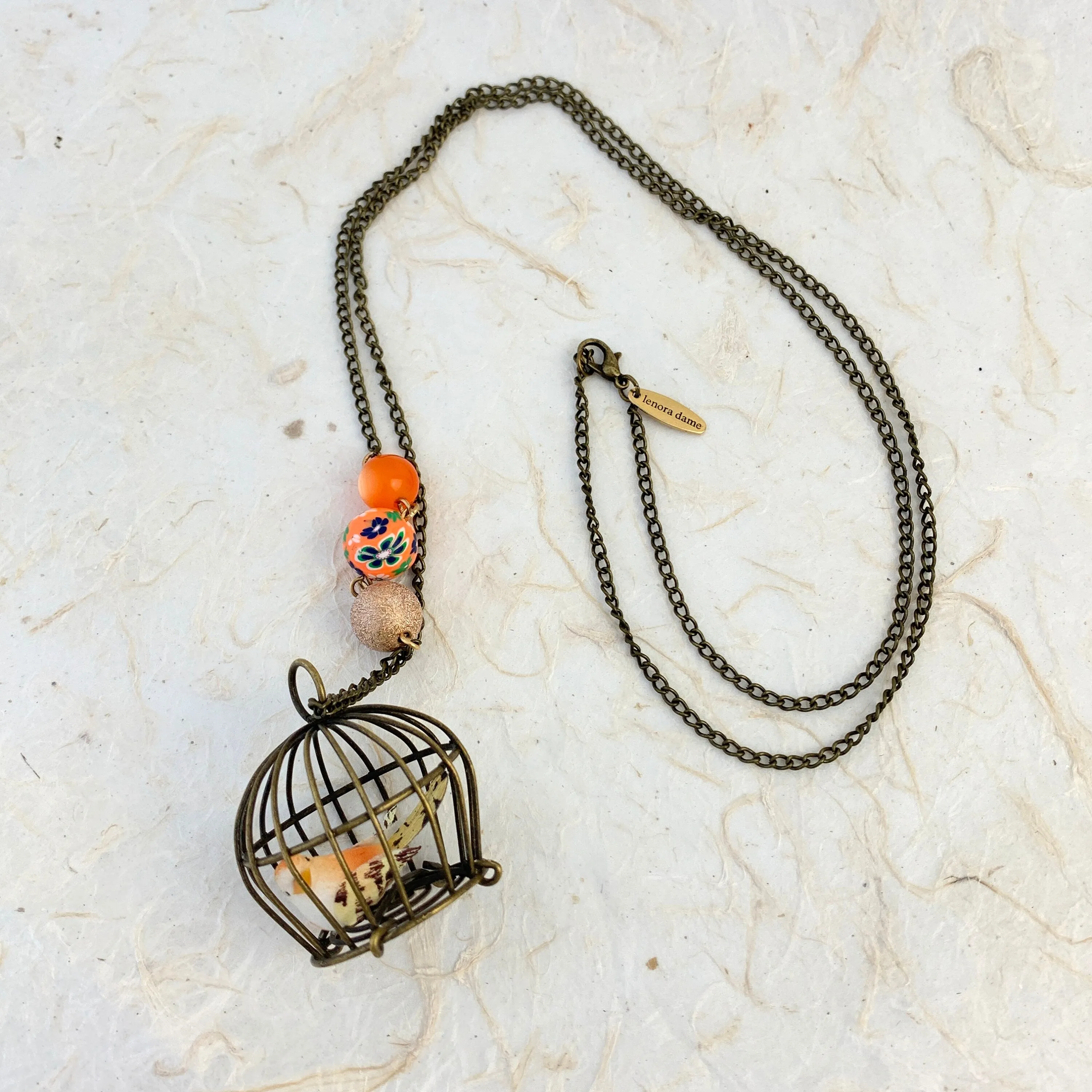 Little Bird In A Vintage Birdcage Pendant Necklace in Begonia