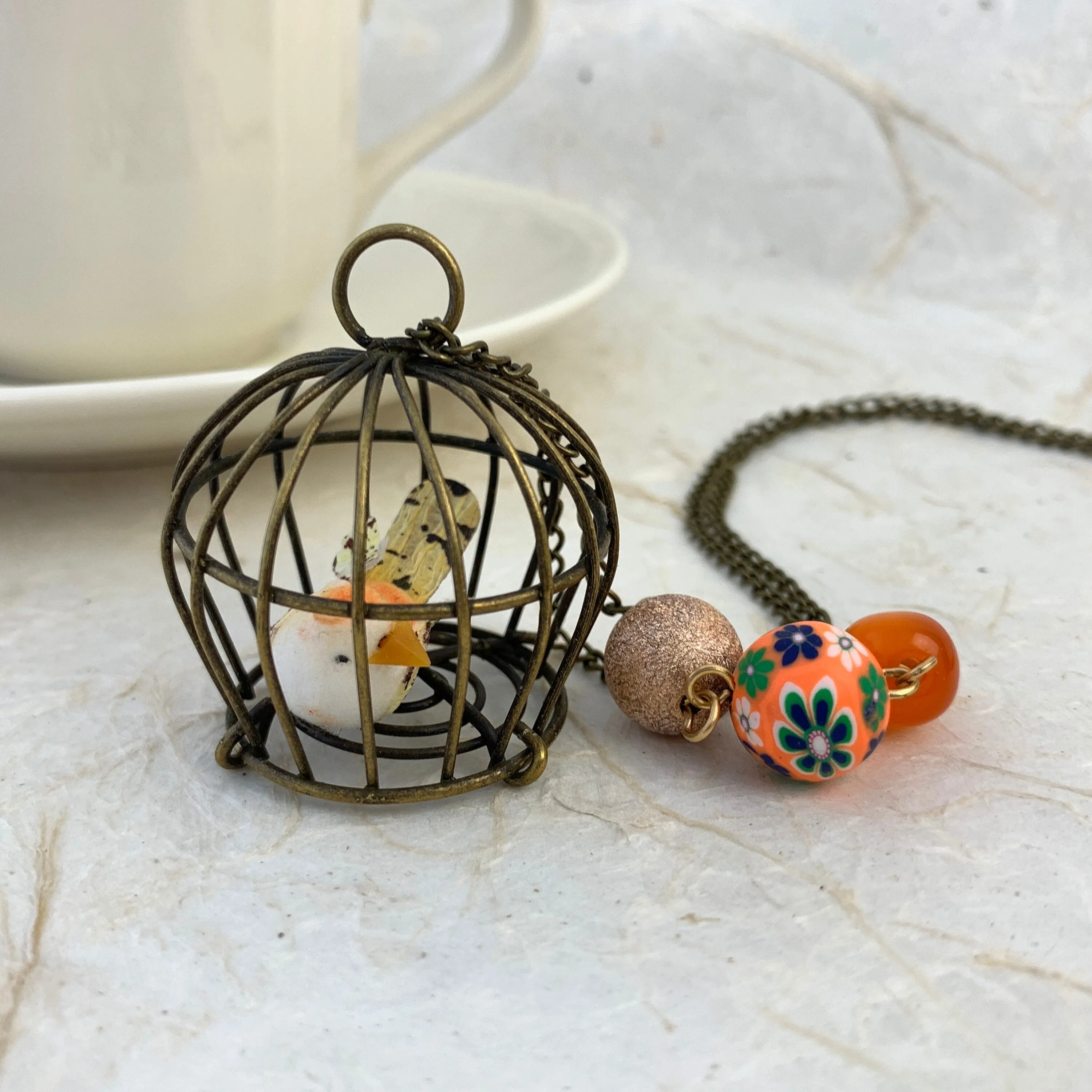 Little Bird In A Vintage Birdcage Pendant Necklace in Begonia